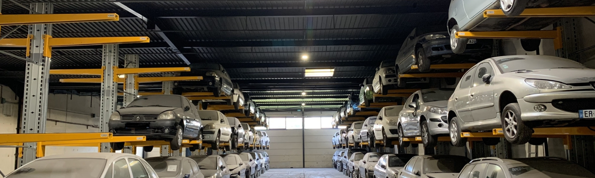Warehouse with cars stored high up on racks