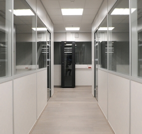 Corridor with glazed office partitions in a company
			